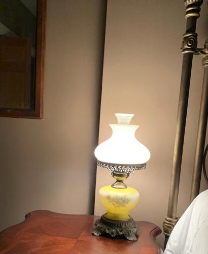 a lamp sitting on top of a table at Pope House - Hist. Mansion - The Gold Rush Suite in Helena