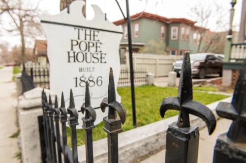 a black fence with a sign in front of a house at Pope House - Hist. Mansion - The Gold Rush Suite in Helena