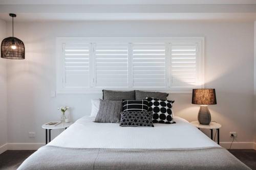 a bedroom with a bed with pillows and a window at 'Austin' Mudgee in Mudgee