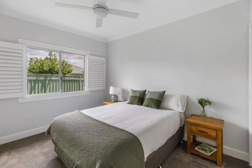 a white bedroom with a bed and a window at 'Austin' Mudgee in Mudgee