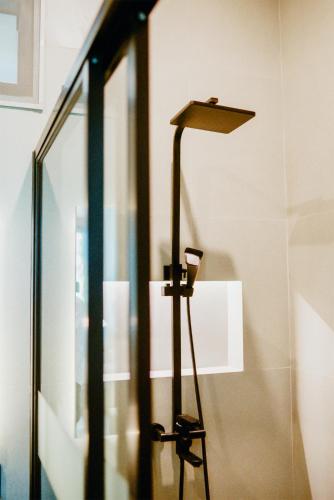 a floor lamp sits next to a glass door at Royal Hill Villa Cisarua Puncak in Puncak
