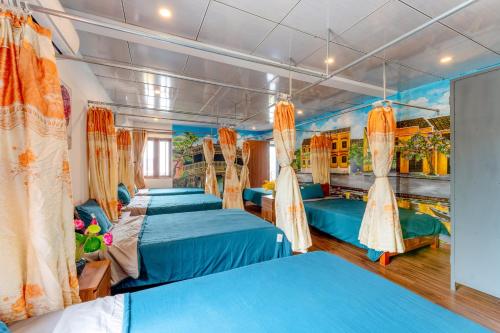 a group of four beds in a room at Alley Garden Homestay Hoi An in Hoi An
