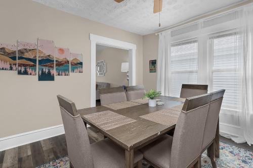 a dining room with a wooden table and chairs at Chic 2BR near DT, 8 min walk to Park&Conservatory in Columbus