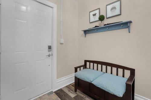 a bedroom with a wooden crib and a white door at Chic 2BR near DT, 8 min walk to Park&Conservatory in Columbus