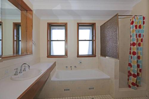 a large bathroom with a tub and a sink at Taranaki Penthouse - wonderful in Port Macquarie