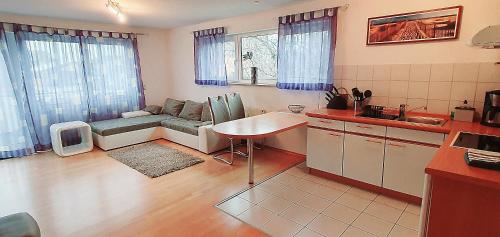 a kitchen and living room with a couch and a table at Ferienwohnung für 5 Personen in Wasserburg in Wasserburg
