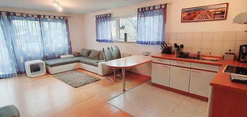 a kitchen and living room with a couch and a table at Ferienwohnung für 5 Personen in Wasserburg in Wasserburg am Bodensee