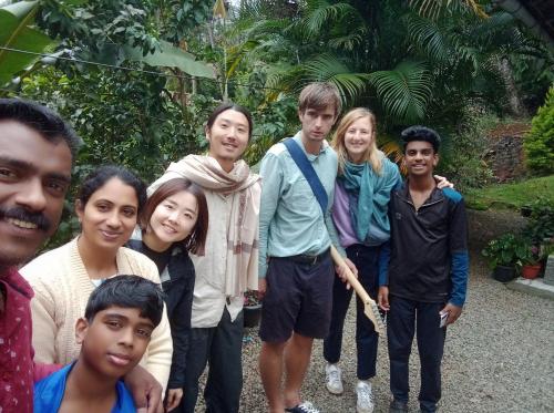 a group of people posing for a picture at Maliyeckal Homestay in Munnar