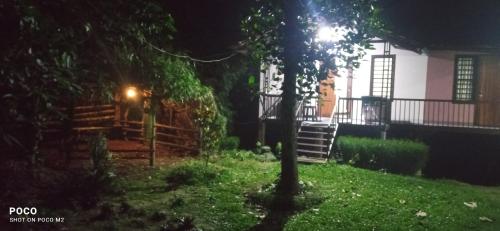 a yard at night with a bench and a house at Family villa is a hut style accommodation in Tariyod