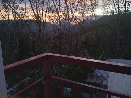 a view of the sunset from the balcony of a house at WinterHome homestay in Munnar