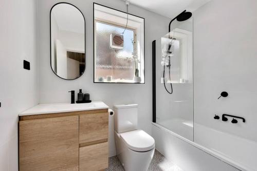 a bathroom with a toilet and a sink and a shower at Acacia South Yarra - Free parking and Wi-Fi in Melbourne