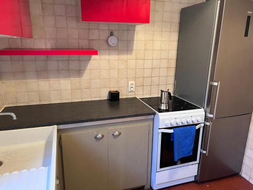 a small kitchen with a stove and a refrigerator at Charming Apartment in Le Cannet in Le Cannet
