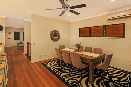 a dining room with a table and chairs at Luxury Holiday Home in Alex - Heated Pool - Pets Allowed in Alexandra Headland