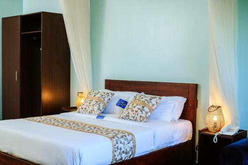 Postel nebo postele na pokoji v ubytování Victoria View Boutique Hotels Kigo
