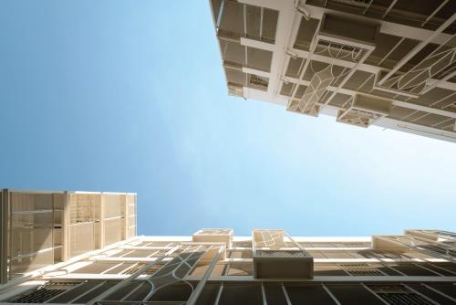 a view of a tall building with a blue sky at YANH Ratchawat Hotel in Bangkok