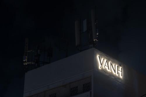 a sign on the side of a building at night at YANH Ratchawat Hotel in Bangkok