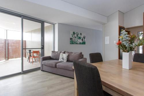 a living room with a couch and a table at Waverley apartment C-one bedroom wifi available in Perth