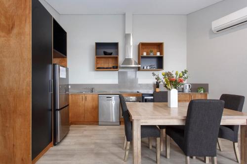 a kitchen and dining room with a wooden table at Waverley apartment C-one bedroom wifi available in Perth