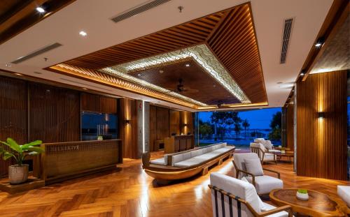 a living room with a couch and a table at Bellerive Hoi An Resort and Spa in Hoi An