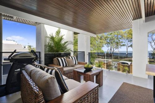 a living room with a couch and a table at 'The Beach House' in Bongaree
