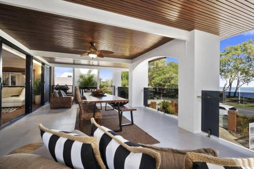 an open living room with a table and chairs at 'The Beach House' in Bongaree