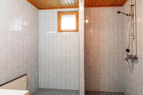 a bathroom with a shower with white tiles at Holiday Home - Detached house 108m2, 3 rooms, 1 living room, Sauna in Joensuu