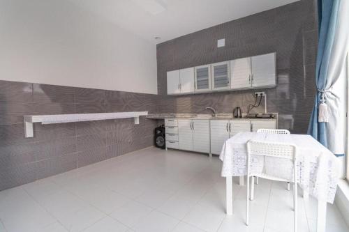 a kitchen with a sink and a table with chairs at شاليهات نبراس in Riyadh