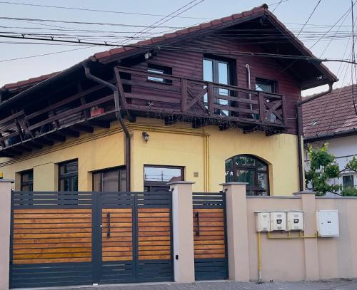 a house with a balcony on top of it at Casa Tamplarului in Alba Iulia