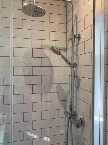 a shower with a glass door in a bathroom at Beautiful country retreat for 6, with free parking in Carlisle