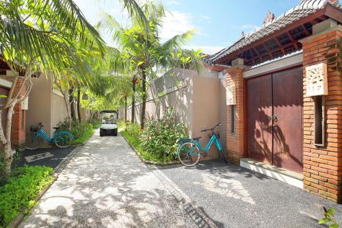 two bikes are parked next to a building at Lumbini Luxury Villas and Spa in Jimbaran