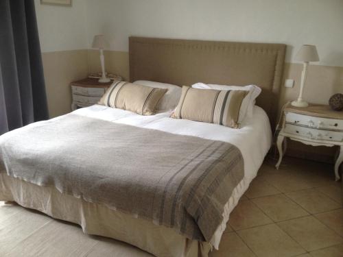 een slaapkamer met een groot bed met 2 kussens bij Maison d'hôtes Urbegia in Ascain