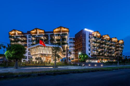a building with a red flag in front of it at Bellerive Hoi An Resort and Spa in Hoi An