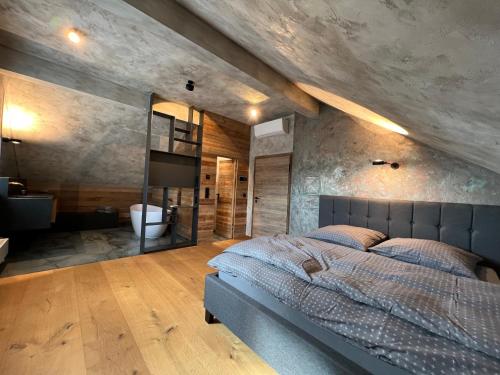 a bedroom with a large bed and a stone wall at Appartement der Extraklasse mit Whirlpool in Roding