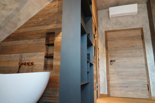 a bathroom with a wooden wall and a door at Appartement der Extraklasse mit Whirlpool in Roding