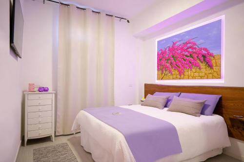 1 dormitorio con 1 cama y una pintura en la pared en Lemon house, en Éboli