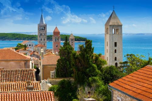 a view of a town with towers and roofs at Apartment in Lopar with sea view, terrace, washing machine 593-4 in Lopar