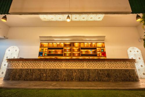 a room with a table and chairs with lights at The Epitome in Kurunegala