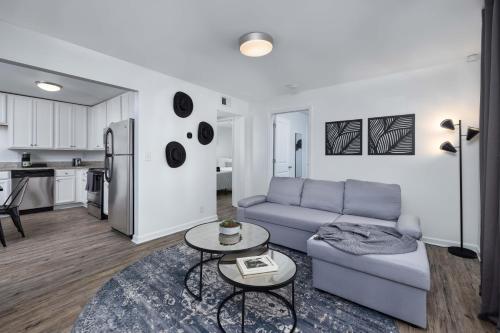 a living room with a couch and a table at The Vibe at Marathon Apartment Suites in Nashville