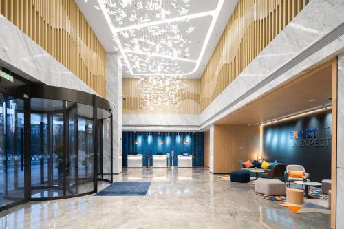 a lobby of a hotel with a chandelier at Holiday Inn Express Nanchang Riverside by IHG in Nanchang