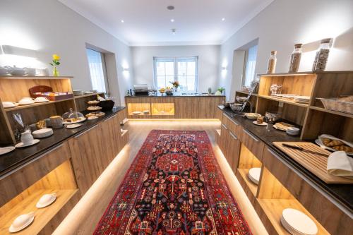 a large kitchen with a large rug in the middle at Hotel Admiral am Kurpark in Baden