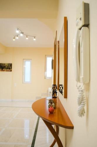 a room with a table and a phone on a wall at Villa Zenovia in Heraklio