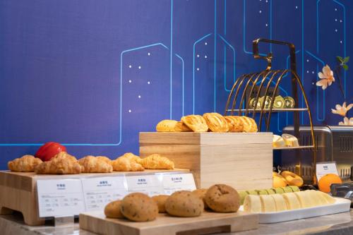 a display of different types of bread and pastries at Holiday Inn Express Nanchang Riverside by IHG in Nanchang