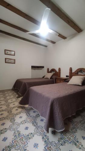 a bedroom with two beds and a ceiling at Finca La Celada in Moratalla