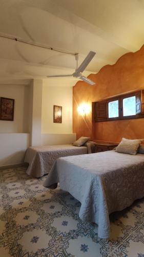 a hotel room with two beds and two windows at Finca La Celada in Moratalla