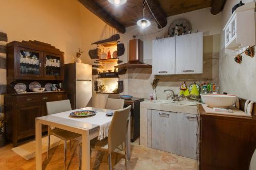 a kitchen with a table and chairs in a room at Antica dimora in Paulilatino
