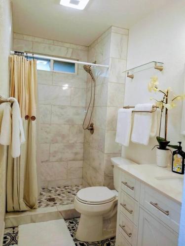 a white bathroom with a toilet and a shower at House, close to Downtown, St Helena, Kenwood in Santa Rosa