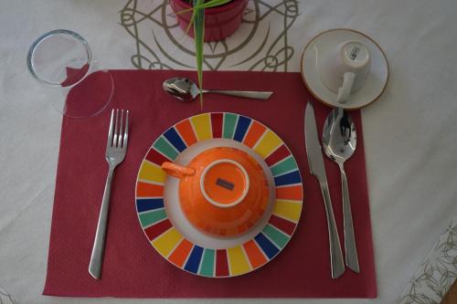 a colorful plate on a table with a red napkin at Dear Mary, B&B romantico vicino Lecce nel cuore del Salento in San Cesario di Lecce