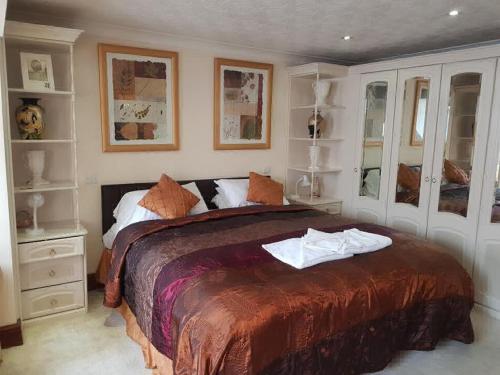a bedroom with a large bed with towels on it at Red Lion Coaching Inn in Epworth