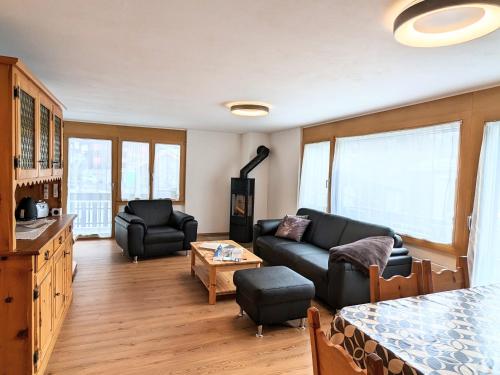 a living room with a couch and a table at Ferienwohnungen Wallis - Randa bei Zermatt in Randa