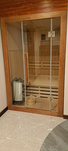 a glass window in a room with a wooden floor at Figaro Apartaments in Gdynia